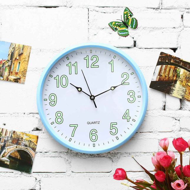 Roze wandklok lichtgevend in donker